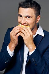 man eating hamburger