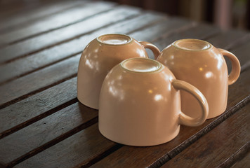 A cup of coffee on a wooden table. Empty coffee cup.