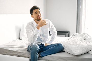 Fototapeta premium portrait of a man sitting on sofa at home