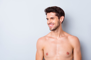 Fototapeta premium Closeup photo of macho guy perfect neat hairstyle looking side toothy smiling naked torso masculine body groomed metrosexual isolated grey background