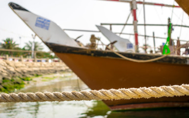 Naklejka premium Traditional fishing boat on the coast with ropes