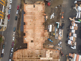 Texture. Construction of complexes with construction equipment and people. Top view. New house construction.