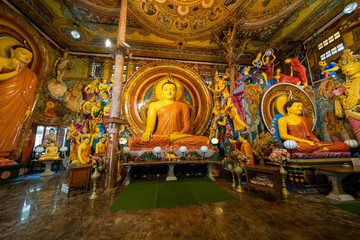 Colombo, Sri Lanka - Interior of Gangaramaya Buddhist Temple with large Buddha statue and shrine
