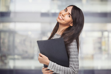 happy young woman with application binder