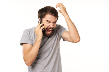 Naklejka premium young man listening to music with headphones isolated on white