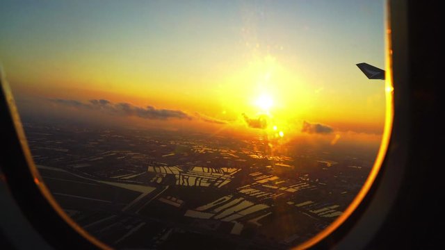sunrise with city view from airplane window