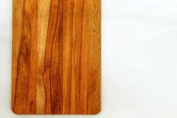 The white background of the horizontal photo shows a wooden Board for cutting and slicing products. The Board is empty, whole and clean. The view from the top