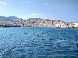 Fototapeta premium Syros, Greece view on the city from cruise chip at summer sunset light