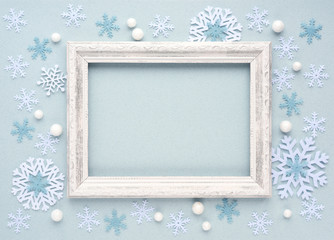 Christmas background. Photo frame and snowflakes on white background. Flat lay, top view, copy space