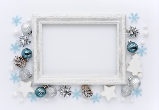 Christmas composition. Photo frame, christmas decorations on white background. Flat lay, top view, copy space
