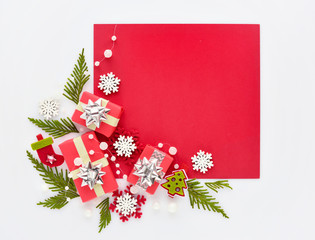 Christmas or New Year greeting card. Gifts and christmas decorations on red and white background. Flat lay, top view, copy space