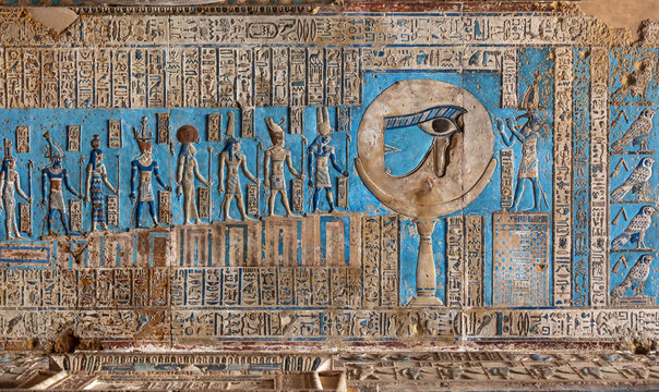 Hieroglyphic carvings and paintings on the interior walls of an ancient egyptian temple