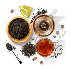 Black tea and accessories top view on white background