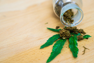 Marijuana. Marijuana Buds in a glass stash jar. Isolated on white. Room for text. Shallow depth of filed. Focus on front Cannabis Flower Bud.