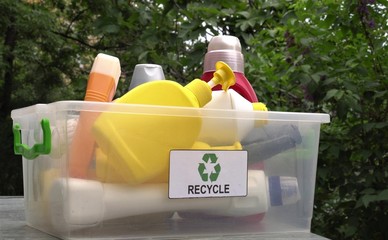 Used empty bottles of household chemicals and body care products. HDPE. Home recycle bin with...