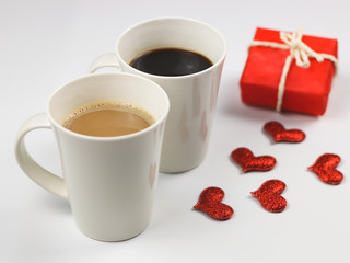 Two coffee up , red gift box and  red glitter hearts decorated on white background , Valentine's day concept.