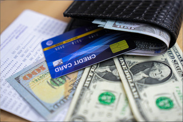 Credit cards and money in leather wallet. Concept of payment. 