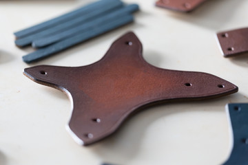 On a light wooden table leather straps.