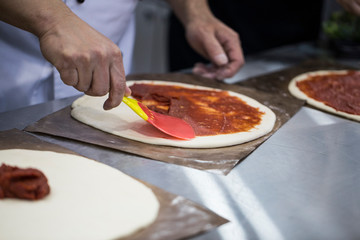 pizza dough with tomato sauce