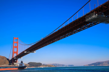 Fototapeta na wymiar Golden Gate Bridge with cargo ship, San Francisco, California, USA