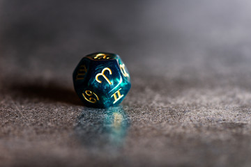 Astrology Dice with zodiac symbol of Aries Mar 21 - Apr 19 on dark background