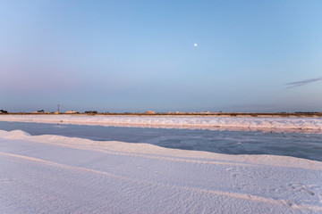 Nature reserve Saline Margherita di Savoia, Apulia, Italy: The salt pan. Salt flats area for sea salt production. A salt marsh, an ecosystem on Adriatic sea. Heaps of salt at sunset ready for harvest