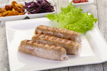 Grilled sausages served mushrooms and cabbage