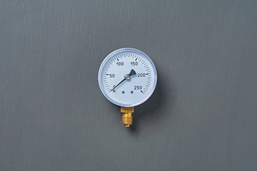 Blue manometer for accurate measurement air or gas pressure lies on dark concrete desk in workshop....