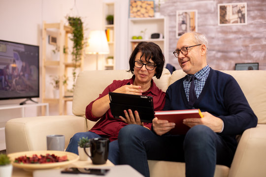 Beautiful old couple using a digital tablet to chat with their family