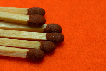Classic matches on an orange background close-up.