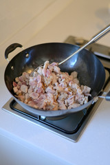 Close-up hand and pan cooking in the kitchen