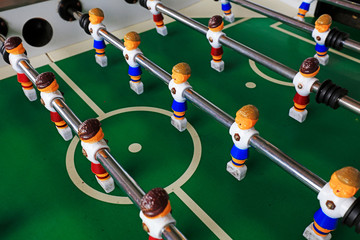 dolls of a retro foosball table to play table football