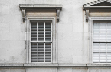 Fototapeta na wymiar Large old fashioned European style neoclassical windows shot straight on.
