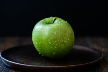 Granny Smith Organic GreenJuicy Apples on Dark Wooden Plate