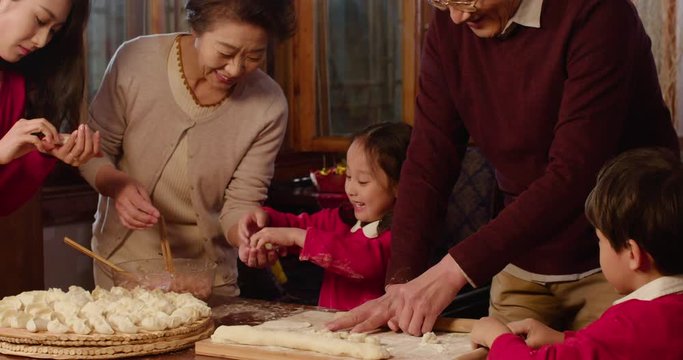Happy family making dumplings at home,4K