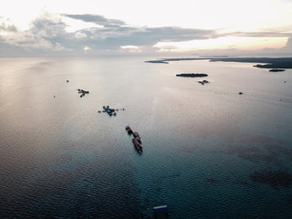 Aerial view of beautiful landscape near the island and sea gypsy water village with the water chalet stilt house during sunrise in Bum Bum island Semporna, Sabah, Malaysia.