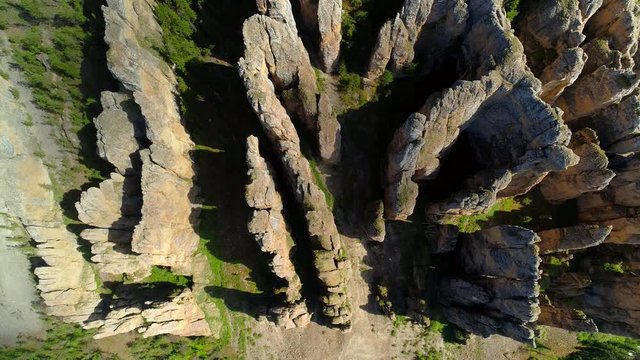 Grand Lena pillars sharp high peaks of vertical rocks stones Russia Yakutsk natural wonder national park reserve Moss-covered cinematic cliffs unique sight wild untouched landscape. Flight top down 
