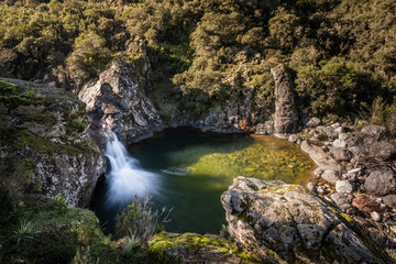 Mountain stream flowing into natural pool in Corsica