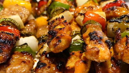 skewers of chicken with vegetables background texture or wallpaper