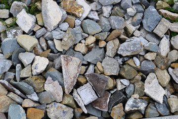 abstract background from stones covered by moss, sharp irregular stones of various types colorful