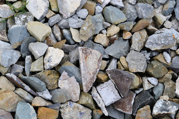 abstract background from stones covered by moss, sharp irregular stones of various types colorful