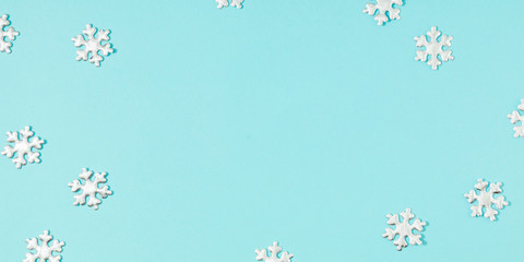 Christmas minimal composition. Snowflakes on pastel blue background. Christmas, New Year, winter concept. Flat lay, top view, copy space