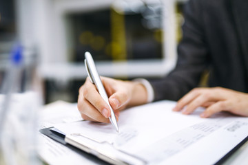 A man signs a contrac, legal or business agreements. Male hand with pen of young office worker...