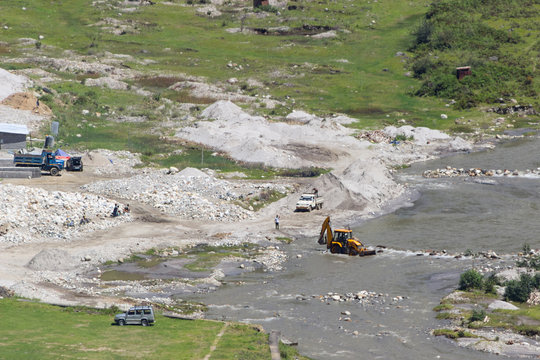 workers are building a bridge across the river