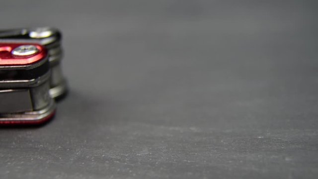 Multi-tool red black on black table surface. Knife opened.