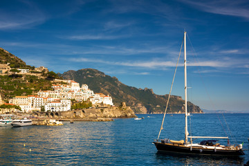 Sailboat in the sea against coastline and a small town