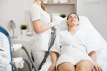 Hardware cosmetology. Face skin care. Skin remodeling. Woman getting facial laser treatment at cosmetology clinic.