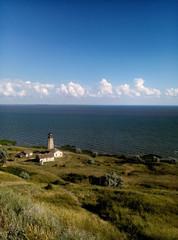beautiful field scenery of the sea clouds and lighthouse dalik