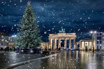 De Brandenburger Tor in Berlijn, Duitsland, met kerstboom & 39 s nachts en sneeuwval © moofushi