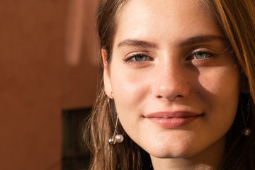 Close up portrait of the attractive cute girl with natural makeup and blue eyes